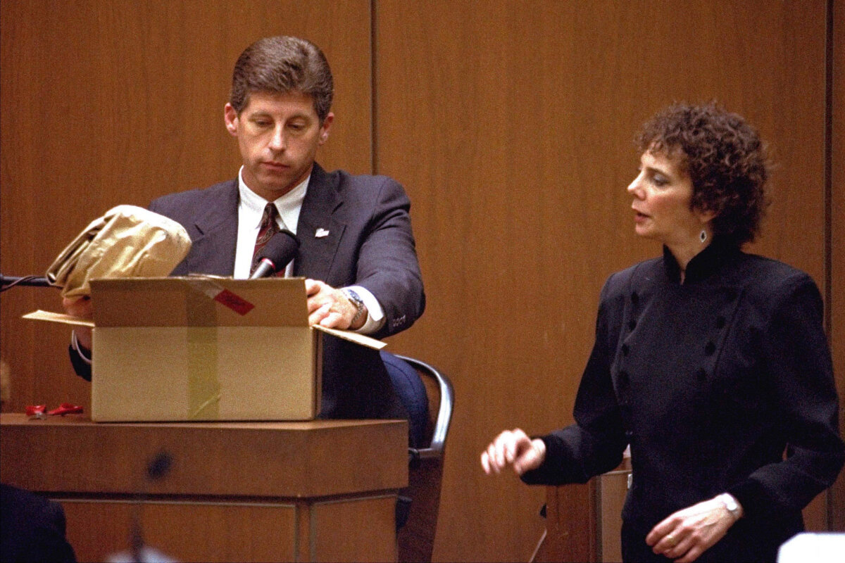 Los Angeles Police Detective Mark Fuhrman shows the jury in the O.J. Simpson double murder trial evidence during testimony Friday, March 10, 1995, in Los Angeles. (Nick Ut/AP Photo)