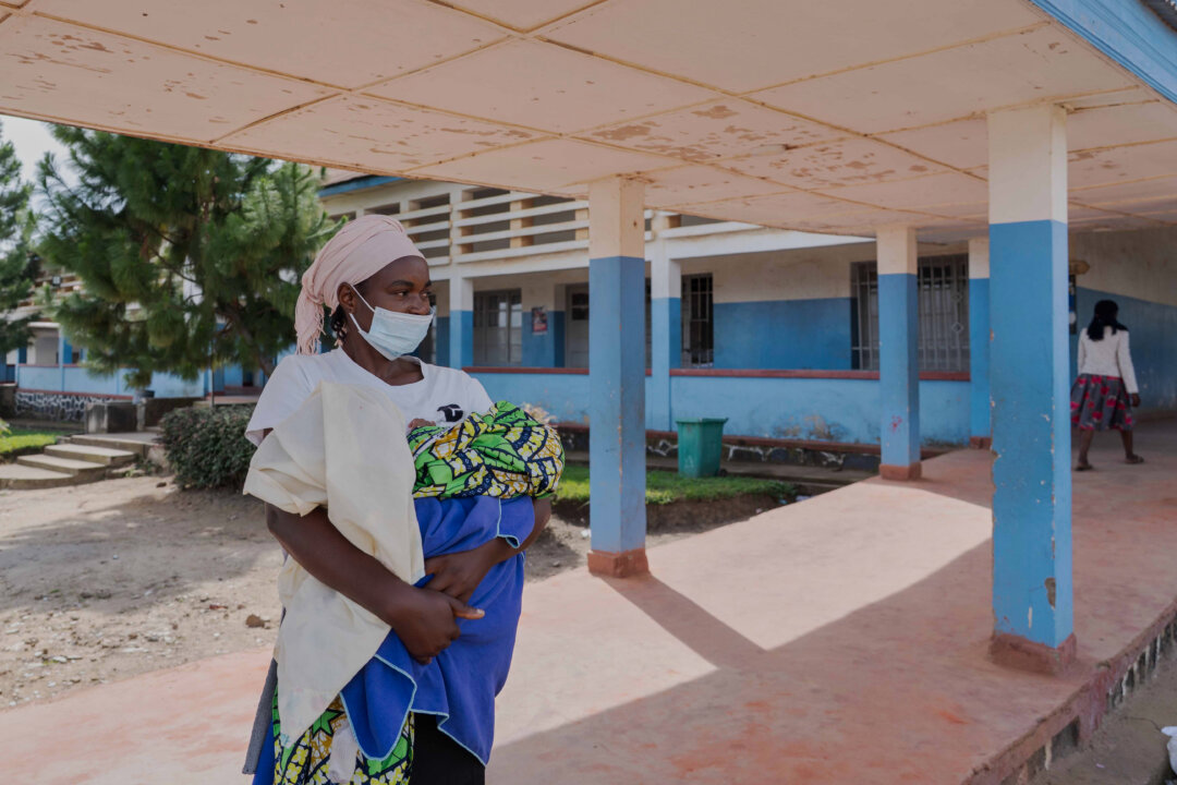 A woman stands outside a hospital in Bunia, Congo, on May 17, 2026. (Dirole Lotsima Dieudonne/AP Photo)
