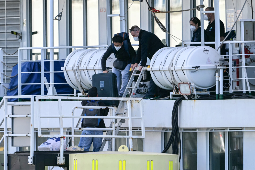 People disembark from the MV Hondius in Rotterdam, Netherlands, on May 18, 2026. (Nicolas Tucat/AFP via Getty Images)