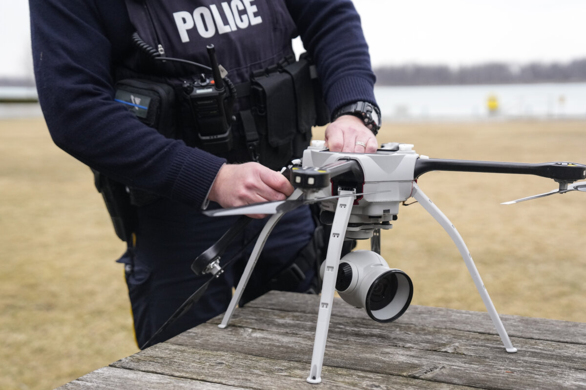 An officer dismantles a drone at an RCMP station in Windsor, Ont., on March 7, 2025. (The Canadian Press/Chris Young)