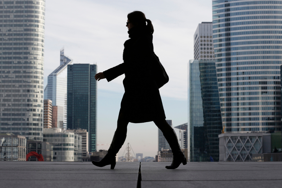 A businesswoman is silhouetted as she makes her way under the Grande Arche de la Défense on Nov. 20, 2012. (Christian Hartmann/Reuters)