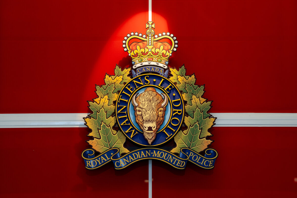 The RCMP crest hangs at a headquarters building in Surrey, B.C., on Feb. 11, 2026. (The Canadian Press/Ethan Cairns)