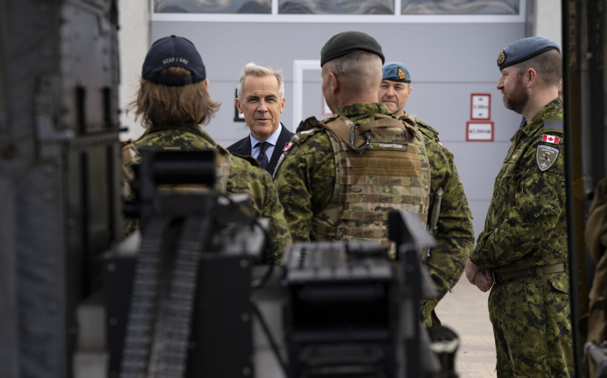 File photo—Prime Minister Mark Carney speaks with members of the Canadian Armed Forces in Adazi, Latvia on Aug. 27, 2025. (The Canadian Press/Christinne Muschi)