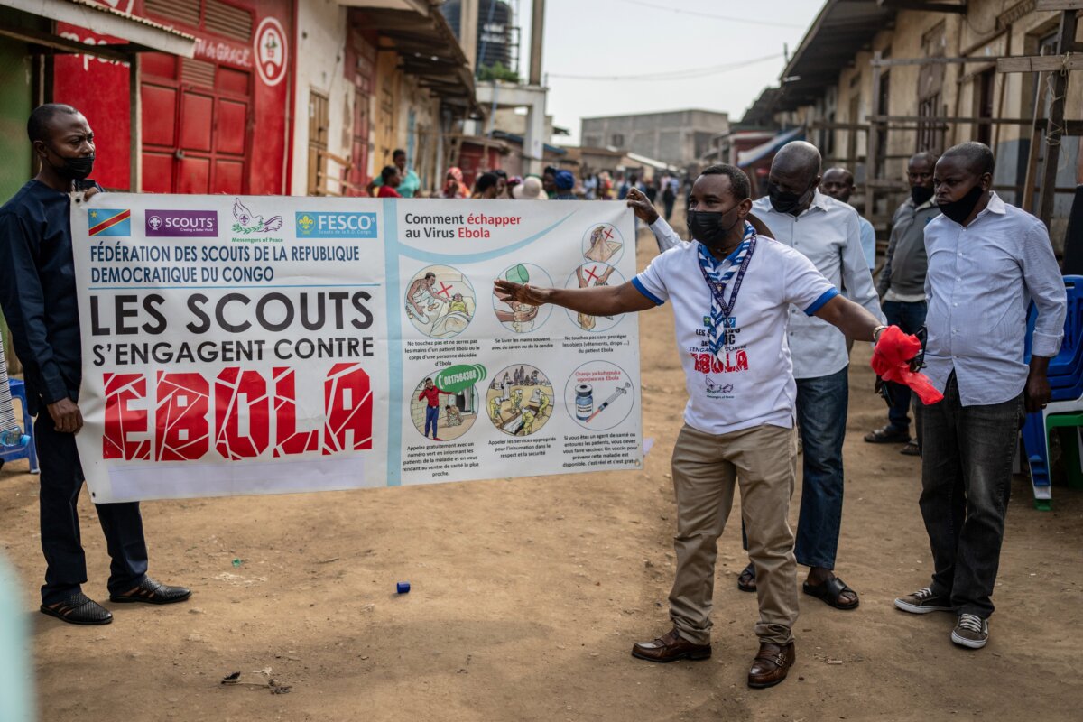 Members of the Congo Scouts movement carry an Ebola awareness banner along a street during a public sensitisation campaign amid the Ebola outbreak in Bunia, Congo, on May 23, 2026. (AP Photo/Moses Sawasawa)