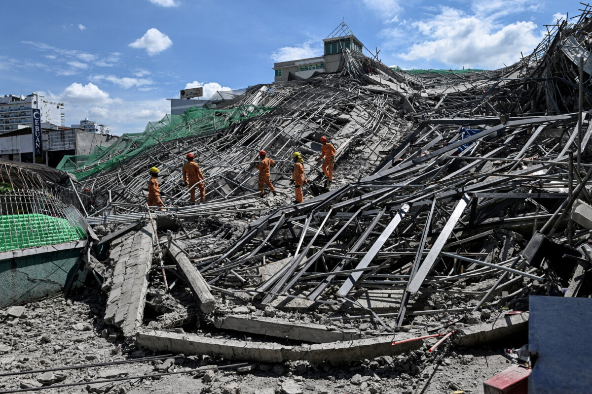Rescue workers search for survivors among debris as a nine-story building under construction collapsed in Balibago, Angeles City, Pampanga, Philippines, on May 24, 2026. (Noel Celis/Reuters)