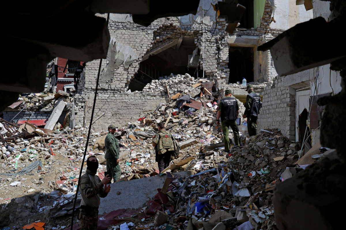 Investigators work amid the debris of a destroyed dormitory building of the Starobilsk College of Luhansk Pedagogical University following a recent attack, which Russian authorities called a Ukrainian drone strike, in the course of the Russia-Ukraine conflict in the town of Starobilsk (Starobelsk) in the Luhansk region, a Russian-controlled area of Ukraine, on May 24, 2026. (Alexander Ermochenko/Reuters)