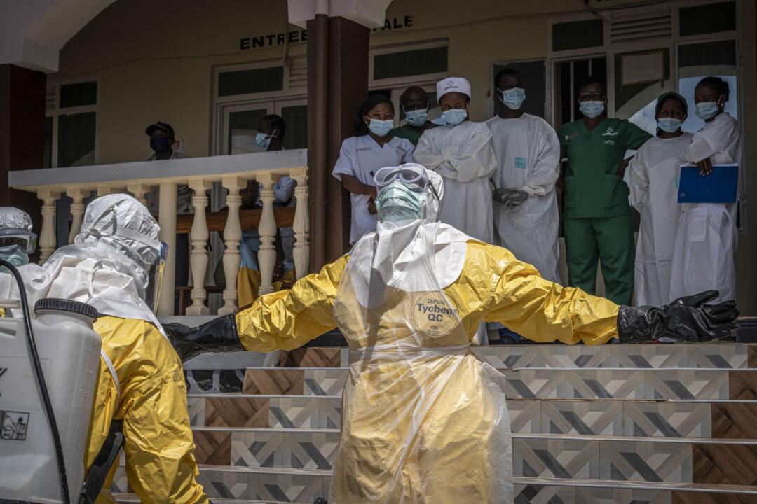 Health workers are sprayed with disinfectant after coming into contact with the body of a person suspected of having died from Ebola in Bunia, in the eastern Democratic Republic of the Congo, on May 25, 2026. (Glody Murhabazi/AFP via Getty Images)