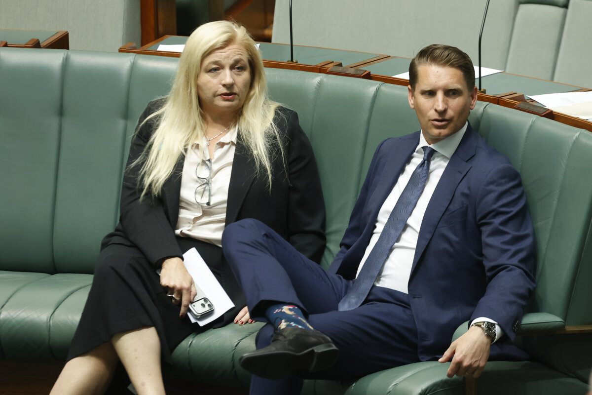 Member for Lyne Alison Penfold (L) speaks to Member for Canning Andrew Hastie (R) at Parliament House in Canberra, Australia, on Feb. 4, 2026. (Hilary Wardhaugh/Getty Images)