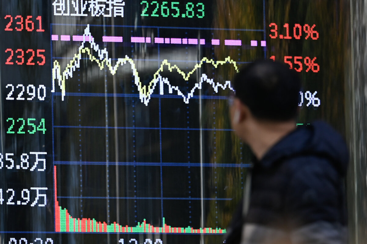 A man looks at a screen showing Chinese stock market movements in Beijing on Nov. 7, 2024. (Wang Zhao/AFP via Getty Images)