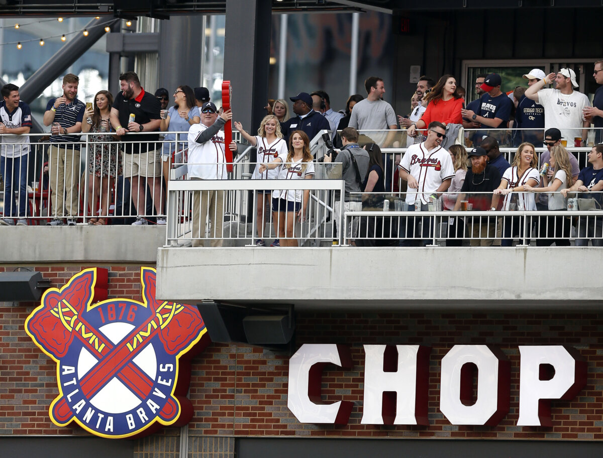 Former Atlanta Braves player Bob Horner (holding the red tomahawk) performs the ceremonial first chop in the first inning of a game between the Braves and the New York Mets at SunTrust Park in Atlanta on April 21, 2018. (Mike Zarrilli/Getty Images)