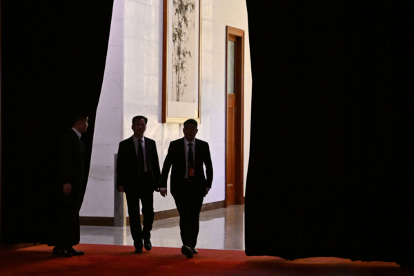 Security officials walk along a hallway at the Great Hall of the People amid preparatory meetings for the third session of the 14th National People's Congress in Beijing on March 4, 2025. (Pedro Pardo / AFP via Getty Images)