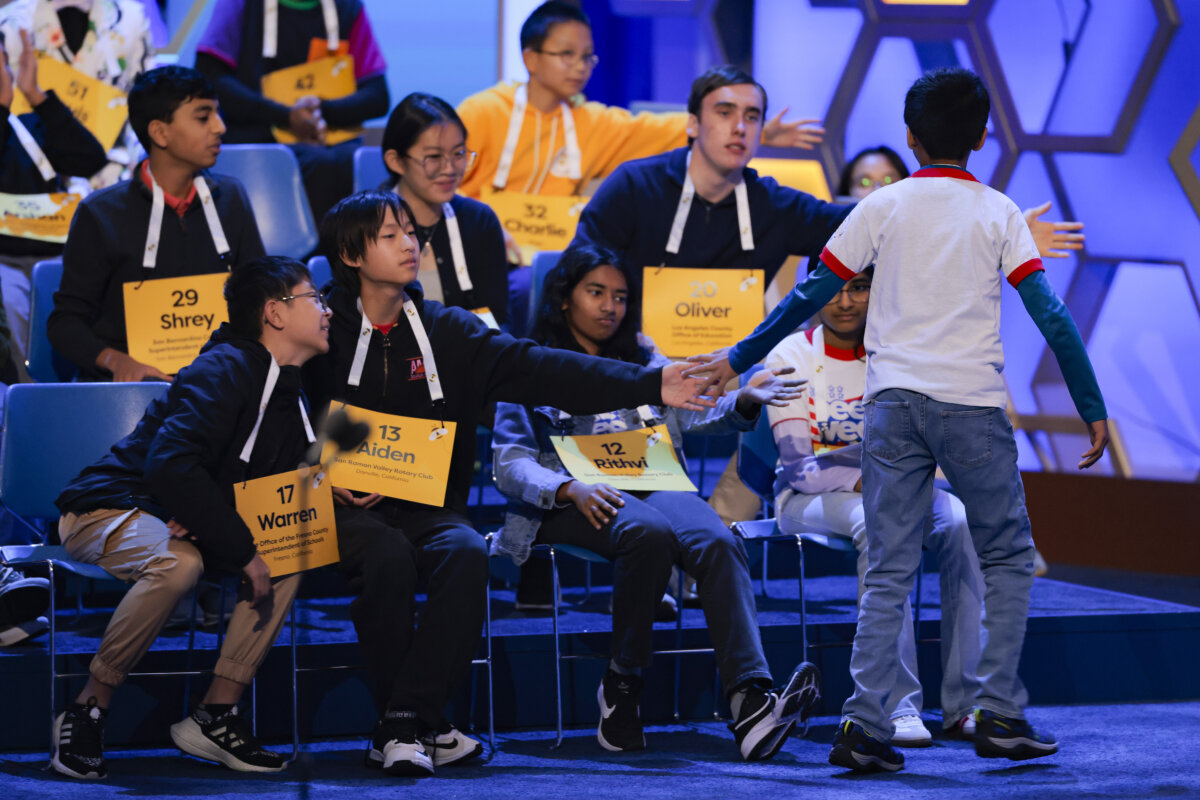 Contestant Sanil Thorat, 10, high-fives his competitors in the Quarterfinals of the Scripps National Spelling Bee at Constitution Hall in Washington on May 27, 2026. (Heather Diehl/Getty Images)