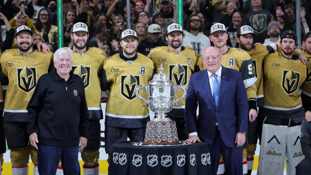 Chairman, CEO and Governor Bill Foley (2nd L) of the Vegas Golden Knights poses with his players as NHL Deputy Commissioner Bill Daly (4th R) presents them with the Clarence S. Campbell Bowl after the team's 2-1 victory over the Colorado Avalanche in Game Four of the Western Conference Final of the 2026 Stanley Cup Playoffs at T-Mobile Arena in Las Vegas, Nevada on May 26, 2026. (Ethan Miller/Getty Images)