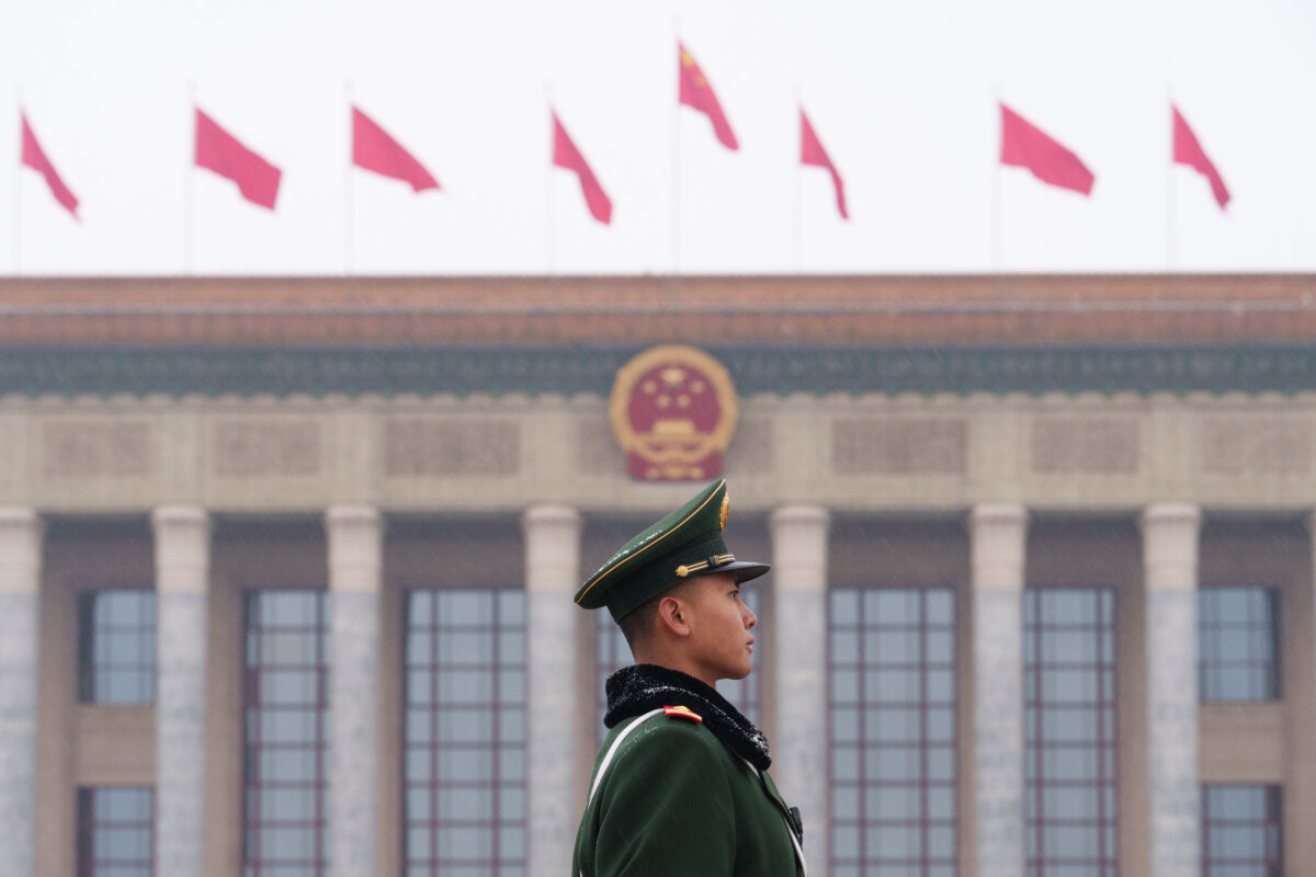A paramilitary police stands guard before the opening session of the National People's Congress (NPC) in Beijing on March 5, 2026. (AP Photo/Vincent Thian)