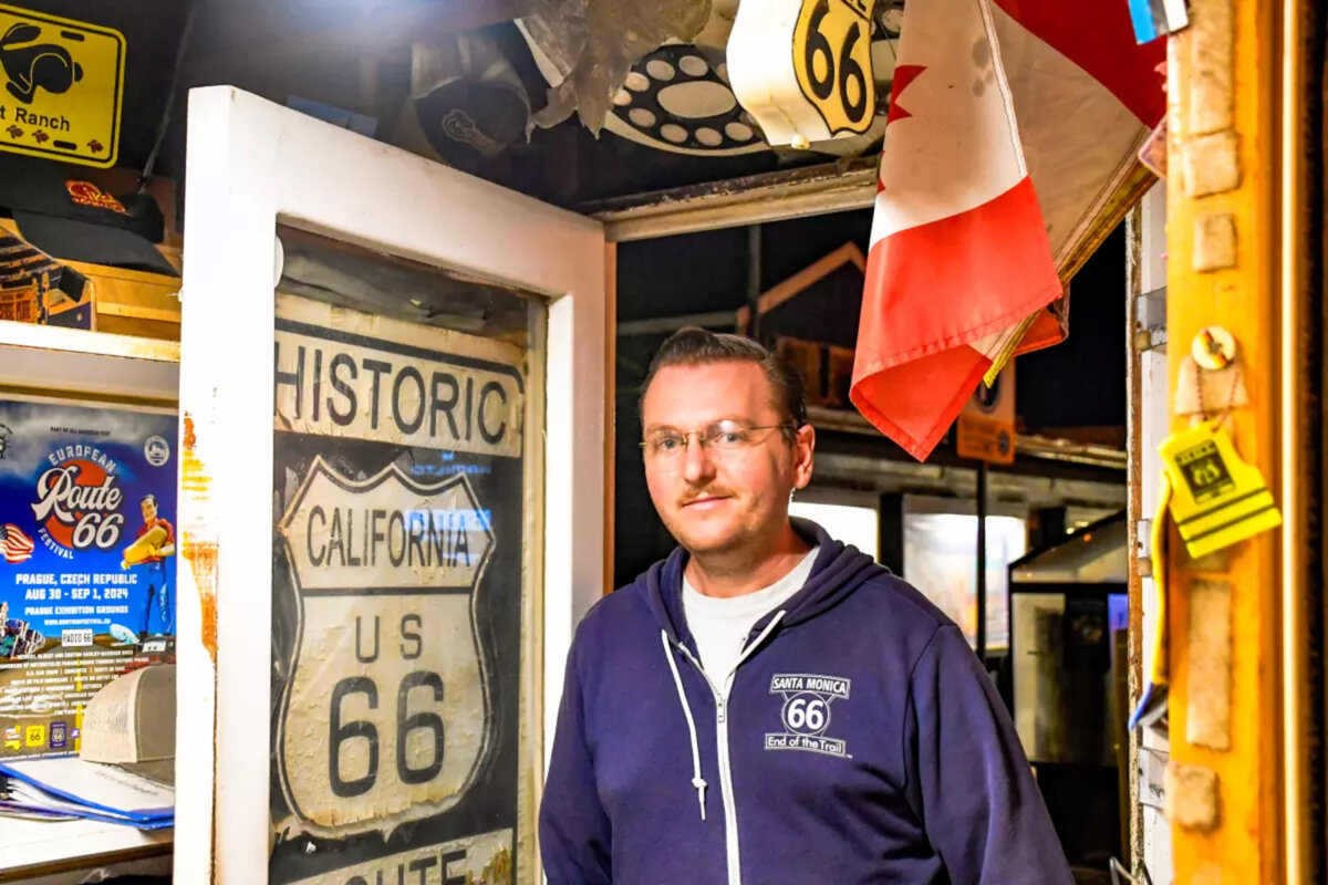 Ian Bowen is manager of the “66 to Cali” shop/kiosk on the Santa Monica Pier. Many travelers go to the kiosk for the Route 66 “passports” and certificates of completion. (Christopher Reynolds/Los Angeles Times/TNS)