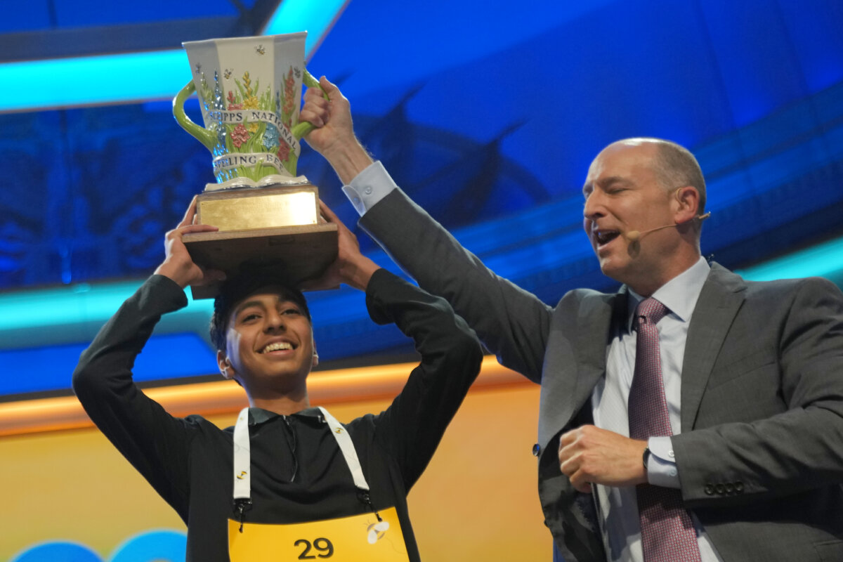 E.W. Scripps Company president and CEO Adam Symson, right, holds the trophy over winner of the 2026 Scripps National Spelling Bee, Shrey Parikh, 14, of Rancho Cucamonga, Calif., at DAR Constitution Hall in Washington, on May 28, 2026. (AP Photo/Allison Robbert)