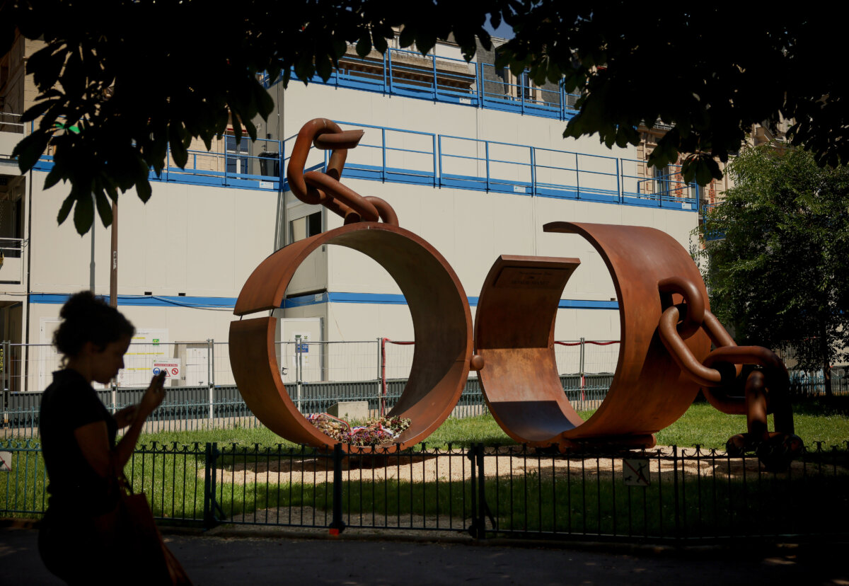 A statue named "Chains," by French artist Driss Sans-Arcidet, honoring the memory of the abolition of slavery, is photographed in a park in Paris on May 27, 2026, as France's National Assembly examines a bill to formally repeal the Code noir. (Thomas Padilla/AP Photo)