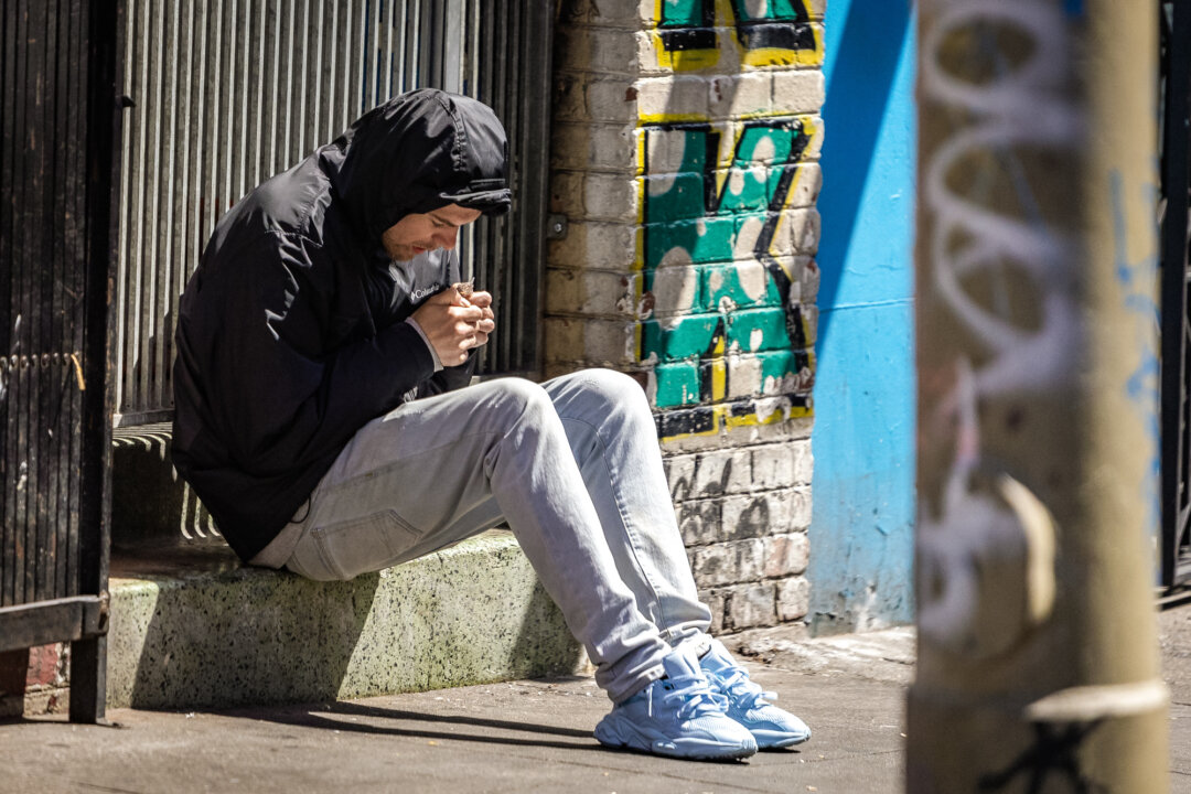 A man uses drugs in the Tenderloin District of San Francisco on May 16, 2024. (John Fredricks/The Epoch Times)