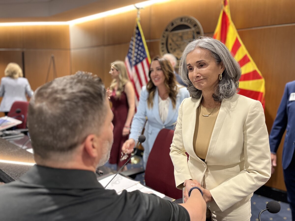 Angel mom Patricia Quets of Arizona speaks with a visitor during a panel discussion on violence related to illegal immigration and drug trafficking at the Arizona Statehouse on May 28, 2026. Quets lost her son, Nicholas, 31, during a cartel hijacking in Mexico. (Allan Stein/The Epoch Times)