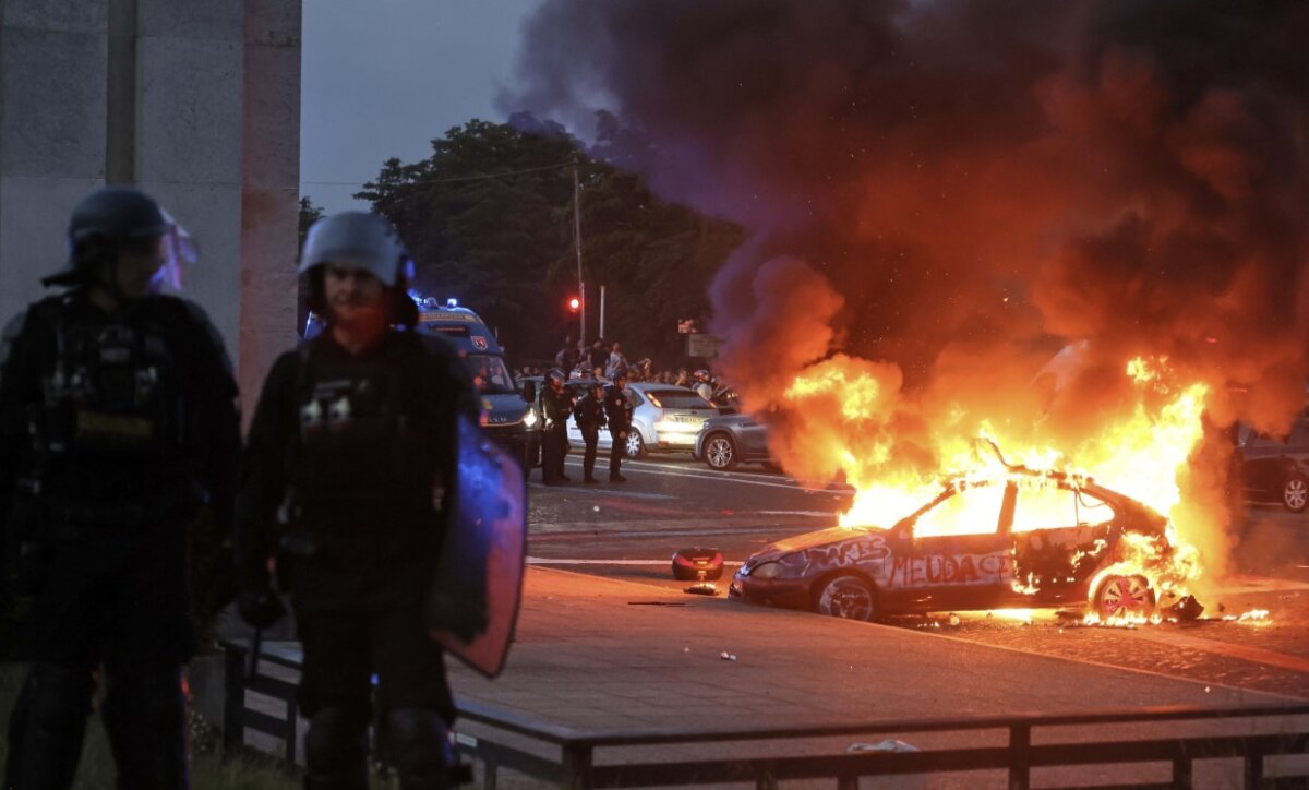 A car burns as Paris Saint-Germain supporters' celebrations of a second successive Champions League success turn into a riot in Paris on May 30, 2026. (Thomas Padilla/AP)