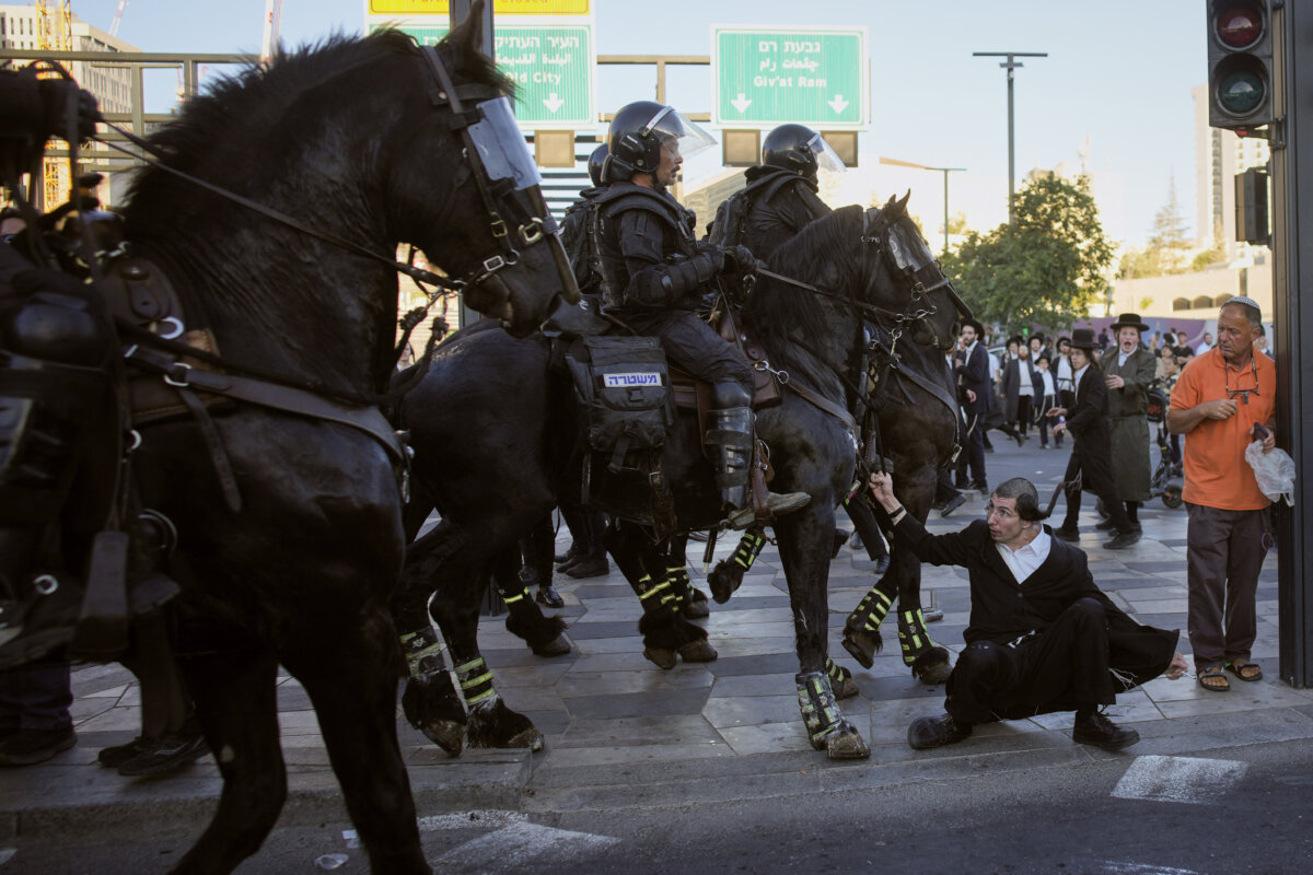 Israeli mounted police disperse Ultra-Orthodox Jews blocking a road during a protest against army draft in Jerusalem, Monday, June 1, 2026. (AP Photo/Ohad Zwigenberg)