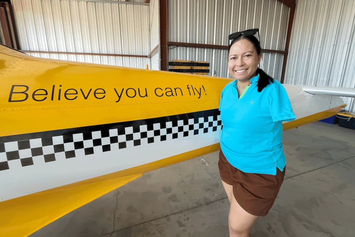 Jessica Cox poses next to and in the cockpit of her 1946 Ercoupe light aircraft in Marana, Ariz., on May 22, 2026. (Allan Stein/The Epoch Times)