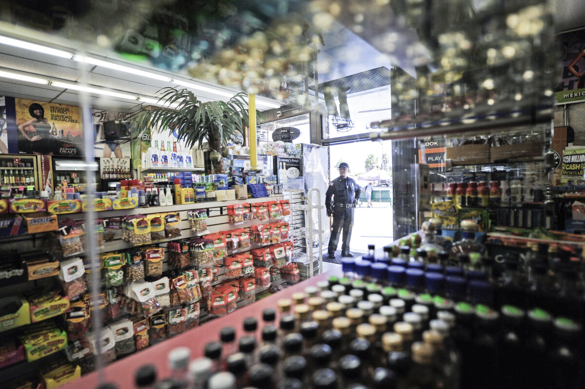 A security officer inside keeps watch at the entrance of a store in Los Angeles, Calif., on April 27, 2012. (Kevork Djansezian/Getty Images)
