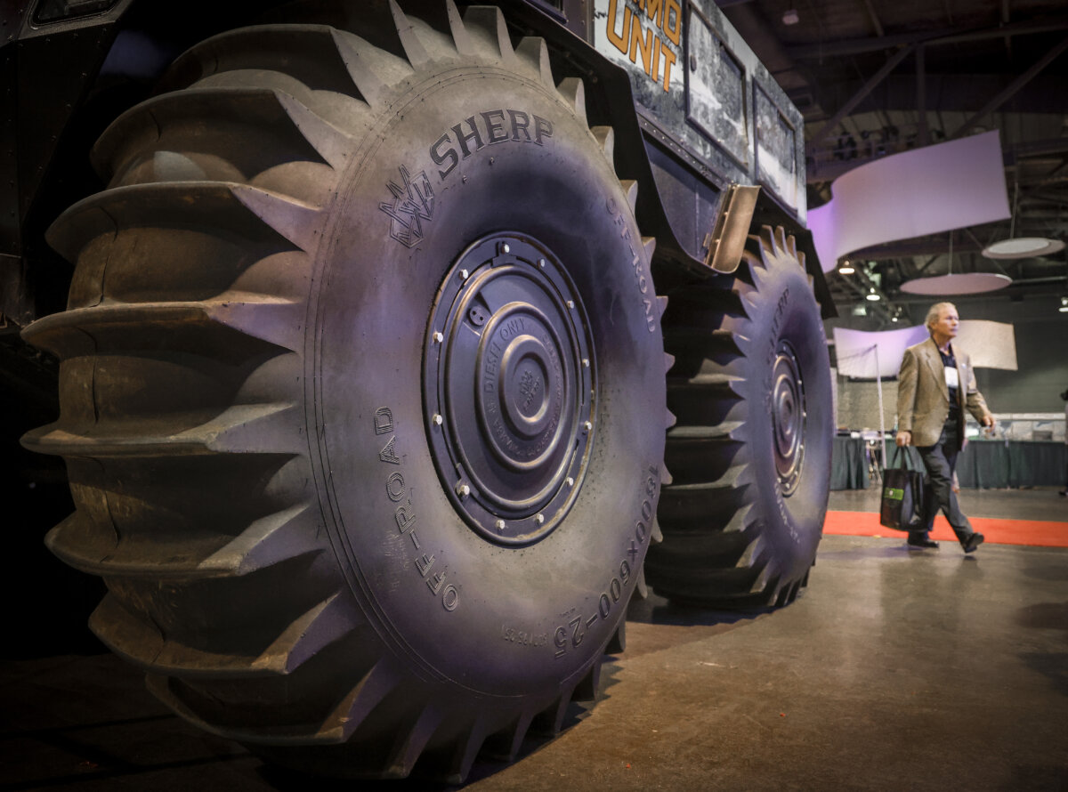 A delegate walks past an all-terrain vehicle at the Global Energy Show in Calgary on June 10, 2025. (The Canadian Press/Jeff McIntosh)