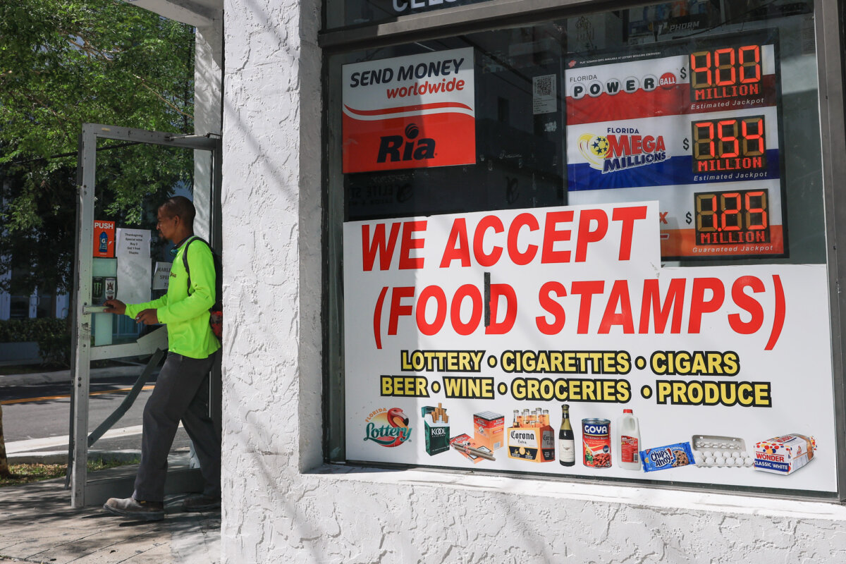A “We Accept (Food Stamps)” sign hangs in the window of a grocery store in Miami on Oct. 31, 2025. (Joe Raedle/Getty Images)