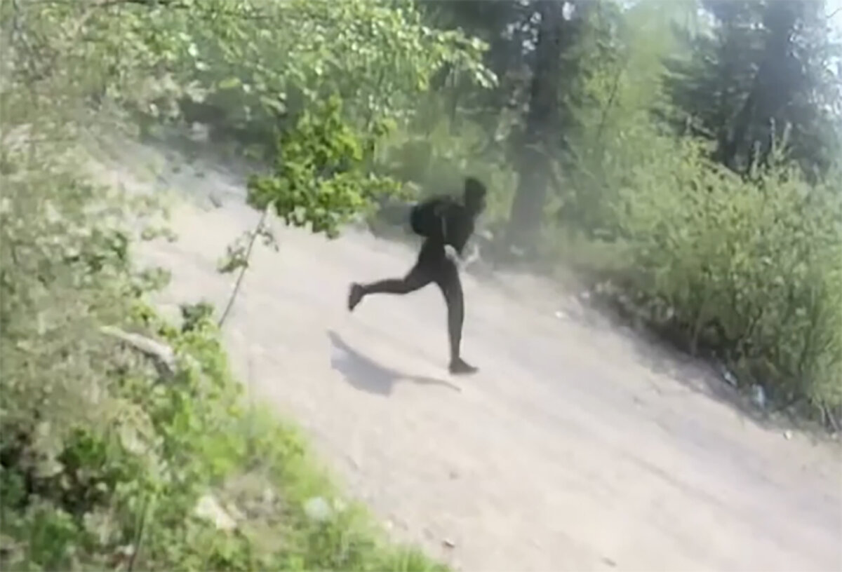 A person is seen in surveillance video running down a road after a shooting in Pelican Narrows, Sask., on June 1, 2026. (The Canadian Press/Handout - RCMP)