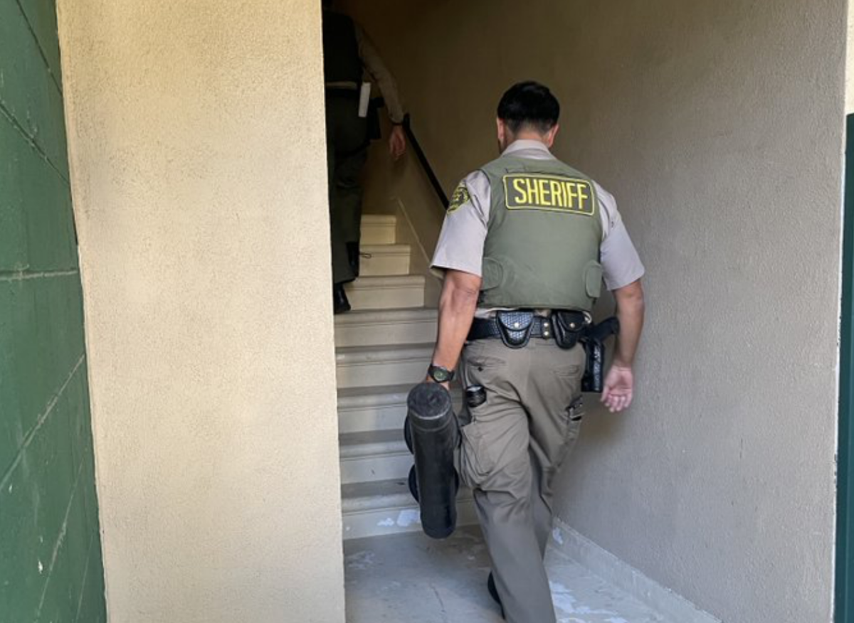 Law enforcement arrives to evict a squatter from a three-bedroom apartment in Santa Monica, California. (Courtesy of Kyle Berg and Avi Sinai)
