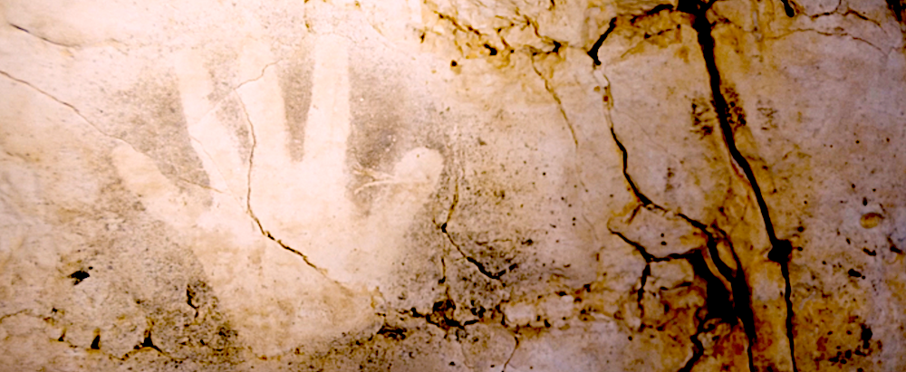 Photo of a hand print on a cave wall in Underland. 