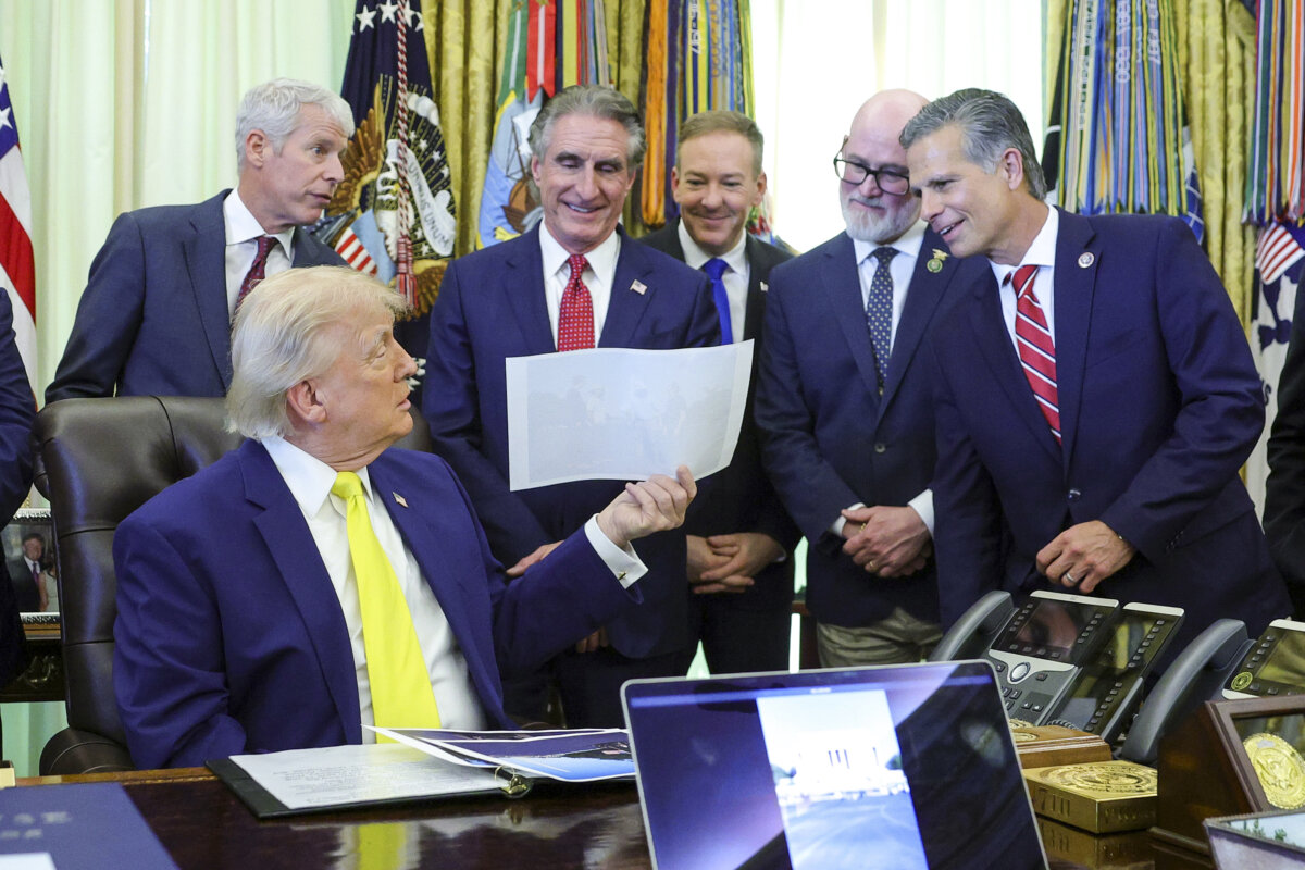 President Donald Trump shows a photo to members of his Cabinet during a "Beautiful, Clean Coal" event in the Oval Office of the White House in Washington on June 4, 2026. (Kevin Dietsch/Getty Images)