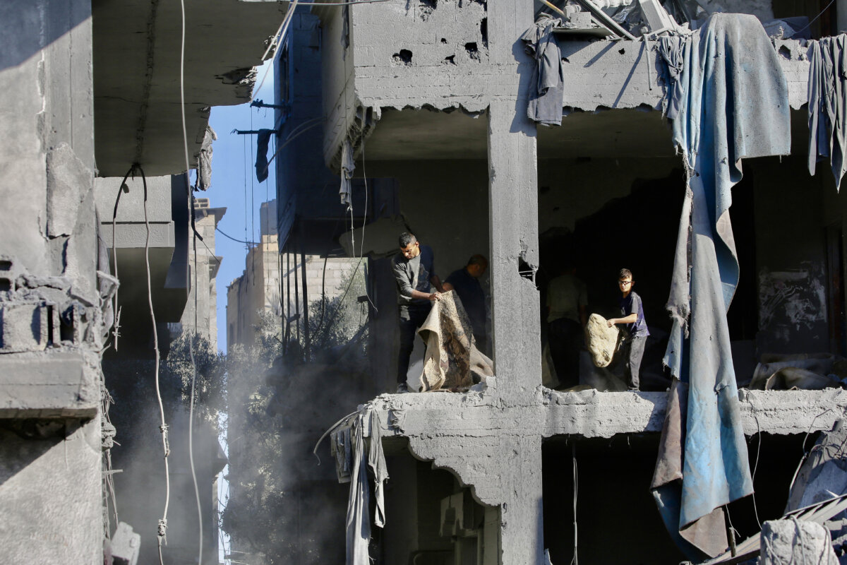 Palestinians clear debris at the site of an Israeli strike on a house whose residents were warned to evacuate before the attack, in Zawaida, central Gaza Strip, on June 5, 2026. (Eyad Baba/AFP via Getty Images)