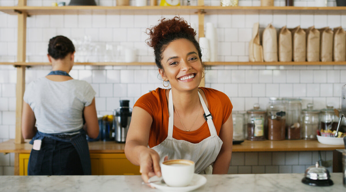 Baristas often provide more than coffee. A friendly greeting and courteous service are among the small acts that help define hospitality. (PeopleImages/Shutterstock)