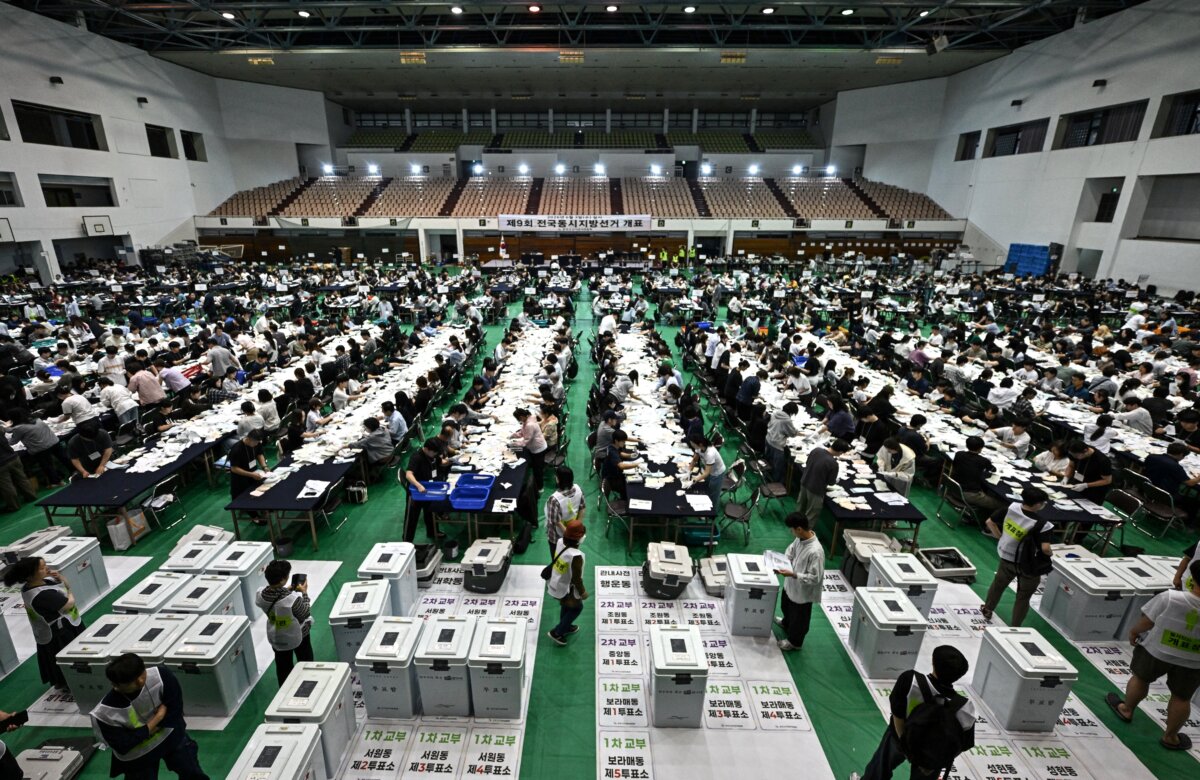 Election officials sort through ballots at a counting station for the local elections in Seoul, South Korea, on June 3, 2026. (Pedro Pardo/AFP via Getty Images)