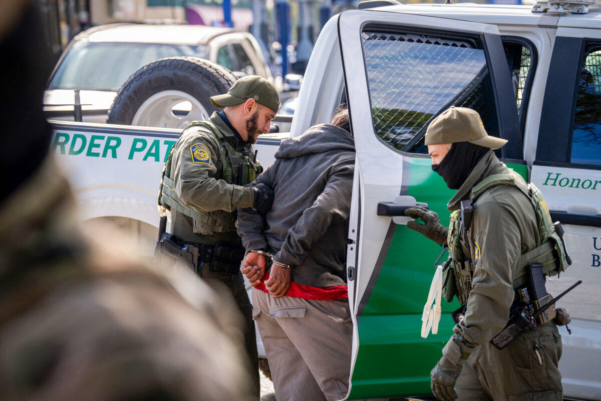 A person is detained by U.S. Customs and Border Protection agents near a hardware store in New Orleans on Dec. 3, 2025. A key part of the Trump administration's program to deport illegal immigrants is expected to reach the Supreme Court. (Adam Gray / AFP via Getty Images)