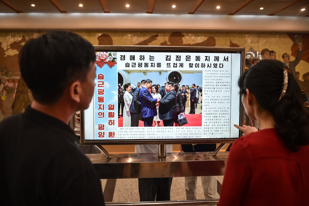 A screen with the newspaper Rodong Sinmun showing the news on the visit of Chinese leader Xi Jinping, in the Kaeson Station of the Pyongyang Metro in Pyongyang on June 9, 2026. (Kim Won Jin/AFP/Getty Images)