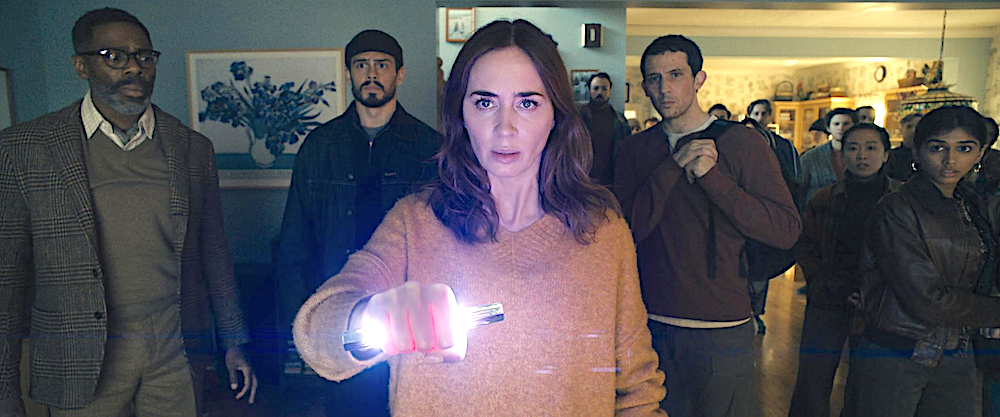 Woman stands in front of a group of people using an alien device in Disclosure Day