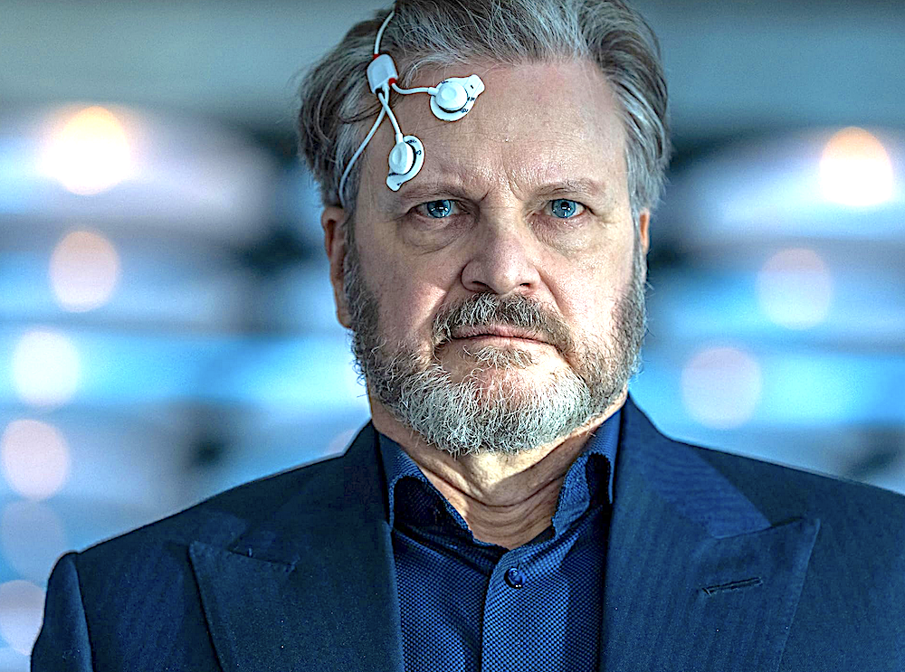 Man in blue shirt with electrodes attached to forehead in Disclosure Day