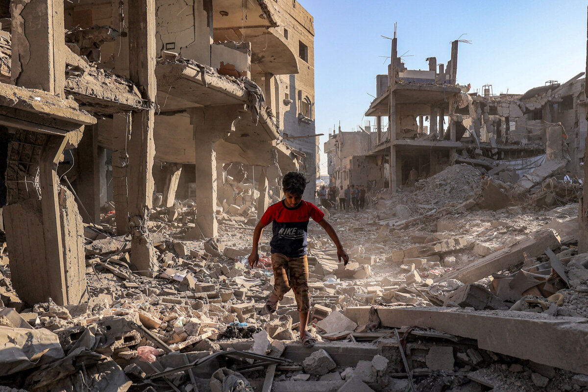 A boy walks through the rubble of a building destroyed in Israeli bombardment following an evacuation order at the Maghazi refugee camp in the central Gaza Strip on June 12, 2026. (Eyad Baba/AFP via Getty Images)