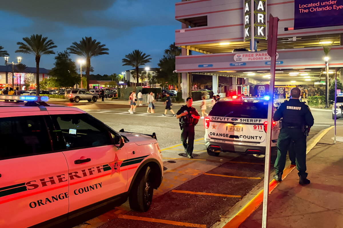 Orange County Sheriff’s Office vehicles are stationed outside Icon Park after a “teen takeover” prompted a heavy law enforcement response in Orlando on May 9, 2026. (Troy Myers/The Epoch Times)