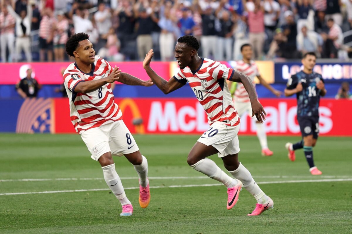 Folarin Balogun, No. 20, of the United States celebrates scoring his team's second goal with Weston McKennie, No. 8, during the FIFA World Cup 2026 Group D match between the United States and Paraguay at Los Angeles Stadium in Los Angeles on June 12, 2026. (Richard Heathcote/Getty Images)
