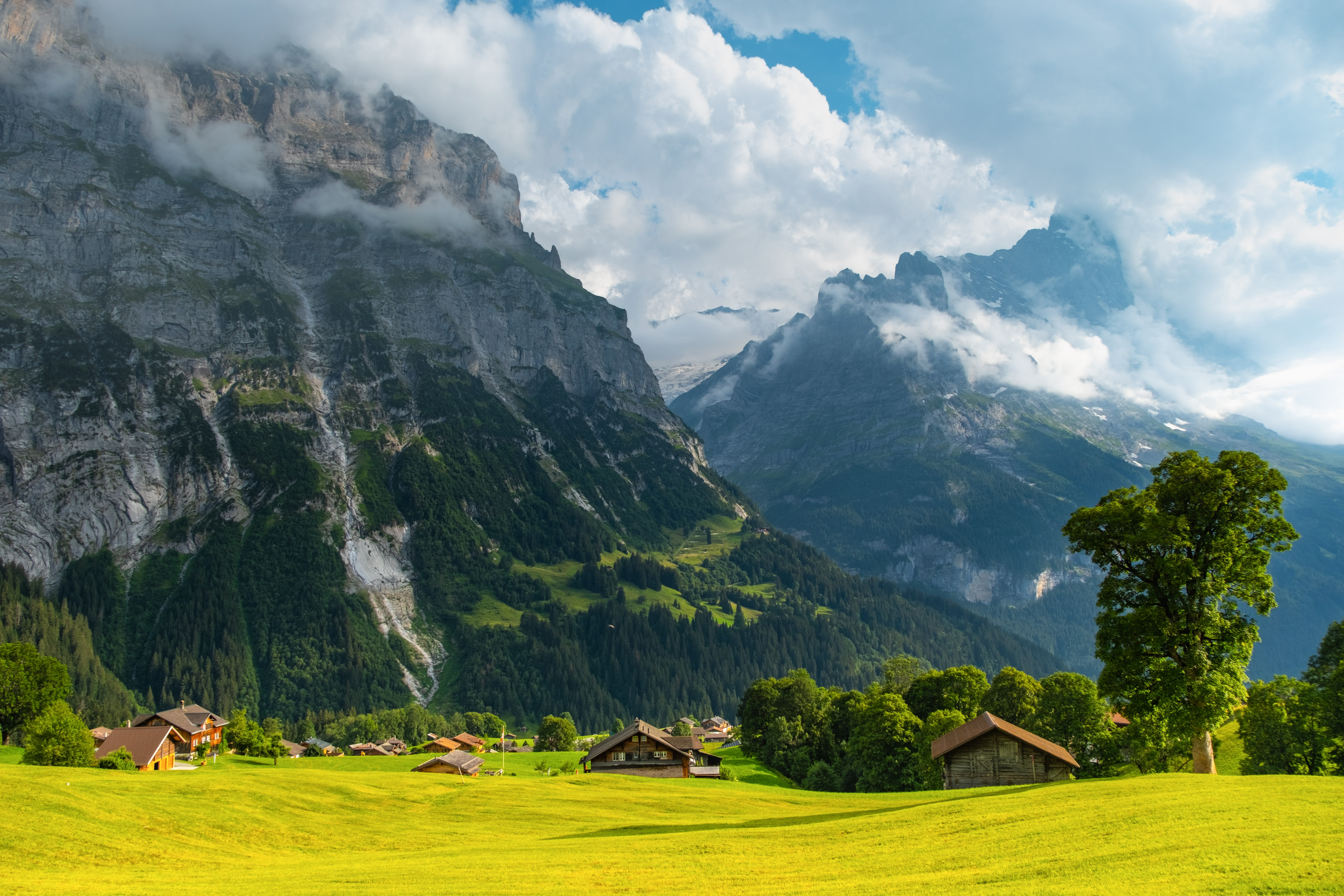 Majestic,Mountains,Rise,In,The,Background,As,Quaint,Wooden,Cabins
