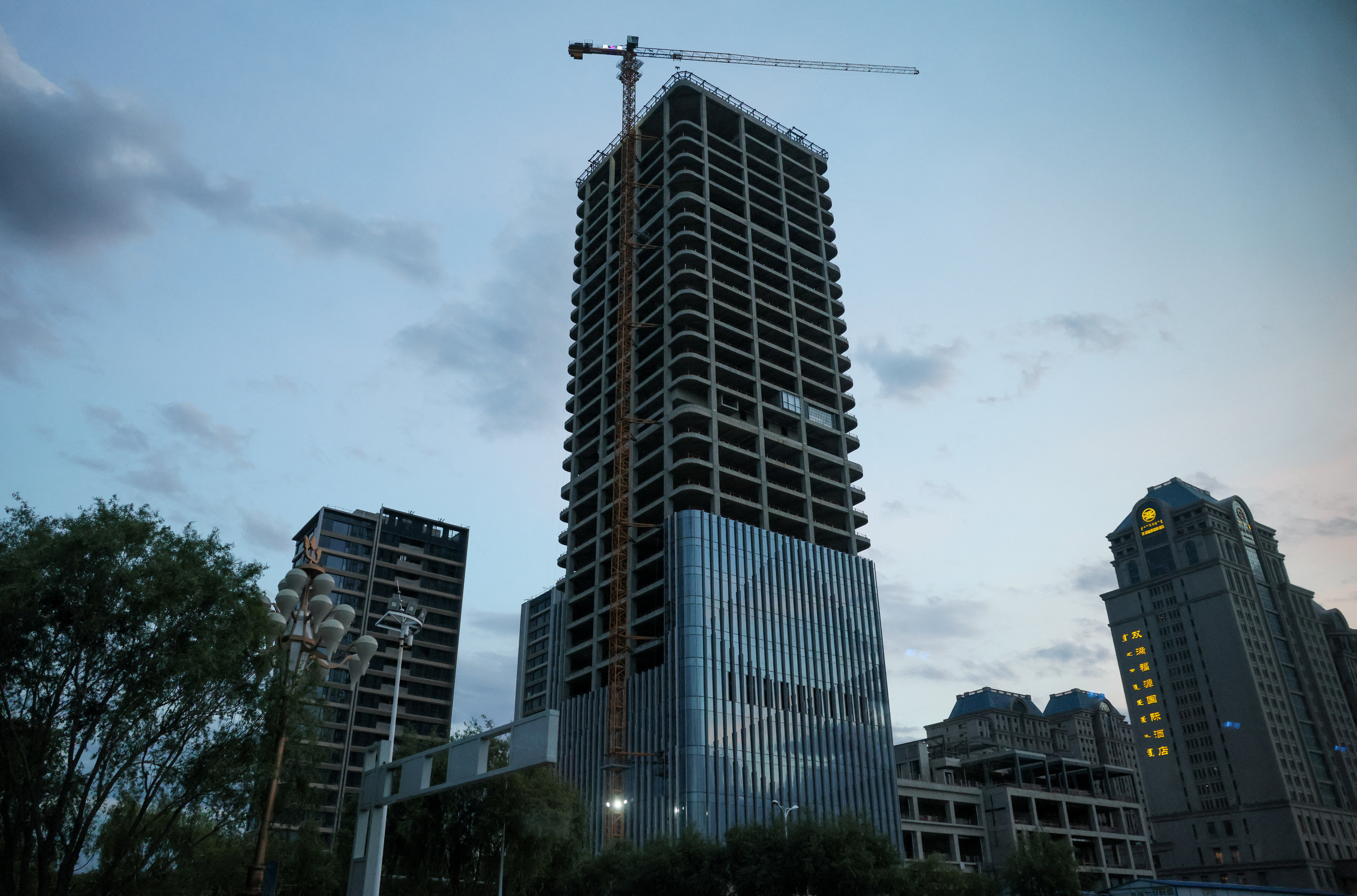 A high-rise building under construction during organized media tour, in Ordos