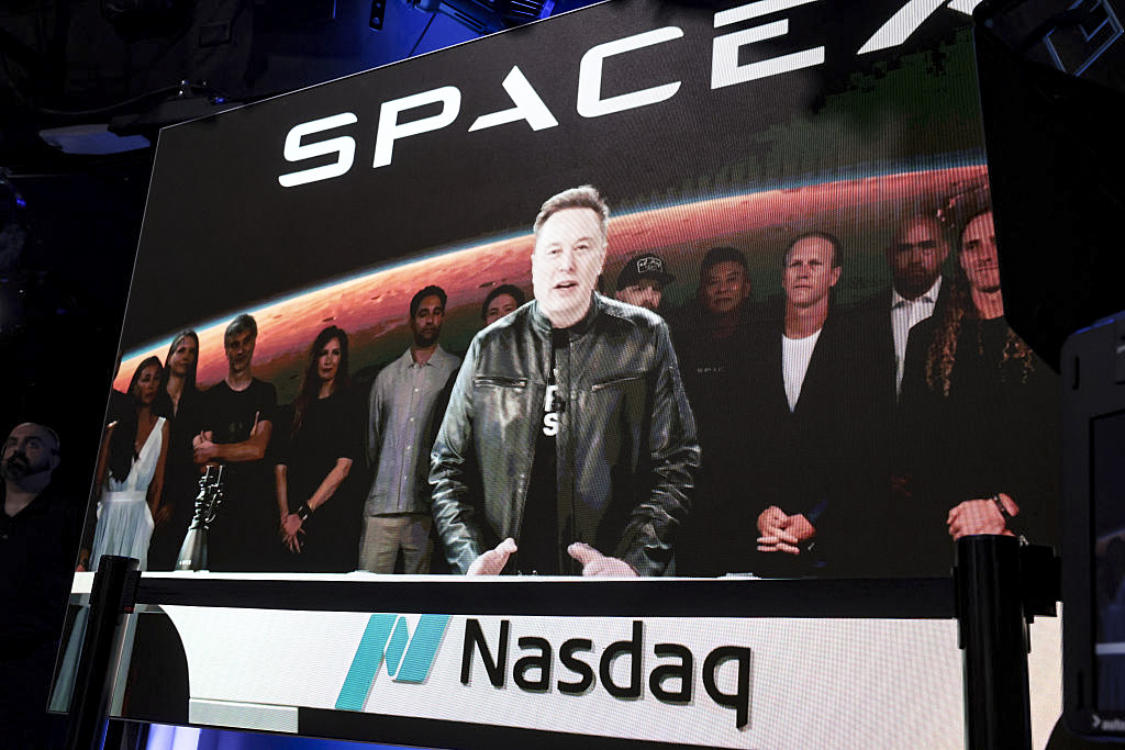SpaceX founder and CEO Elon Musk speaks via video at the Nasdaq Marketsite in Times Square during the launch of the SpaceX initial public offering (IPO) on the Nasdaq in New York City on June 12, 2026. SpaceX, a rocket manufacturing company, began trading Friday under the ticker SPCX following the largest initial public offering ever. Musk, who’s also CEO of Tesla and celebrated from a rocket launch site in Florida, is set to become the world’s first trillionaire. (Spencer Platt/Getty Images)