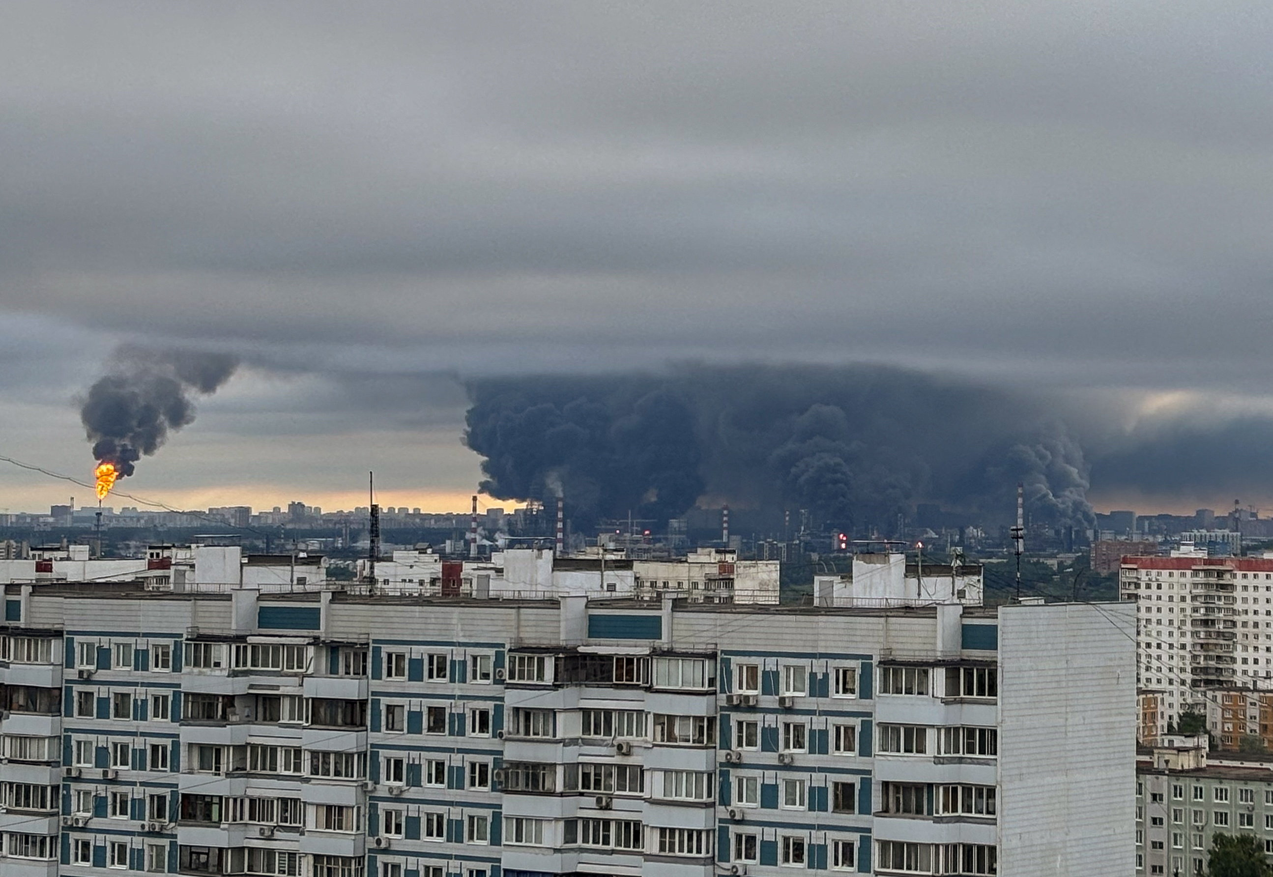 Thick plumes of smoke with flames rise from an oil refinery in Moscow
