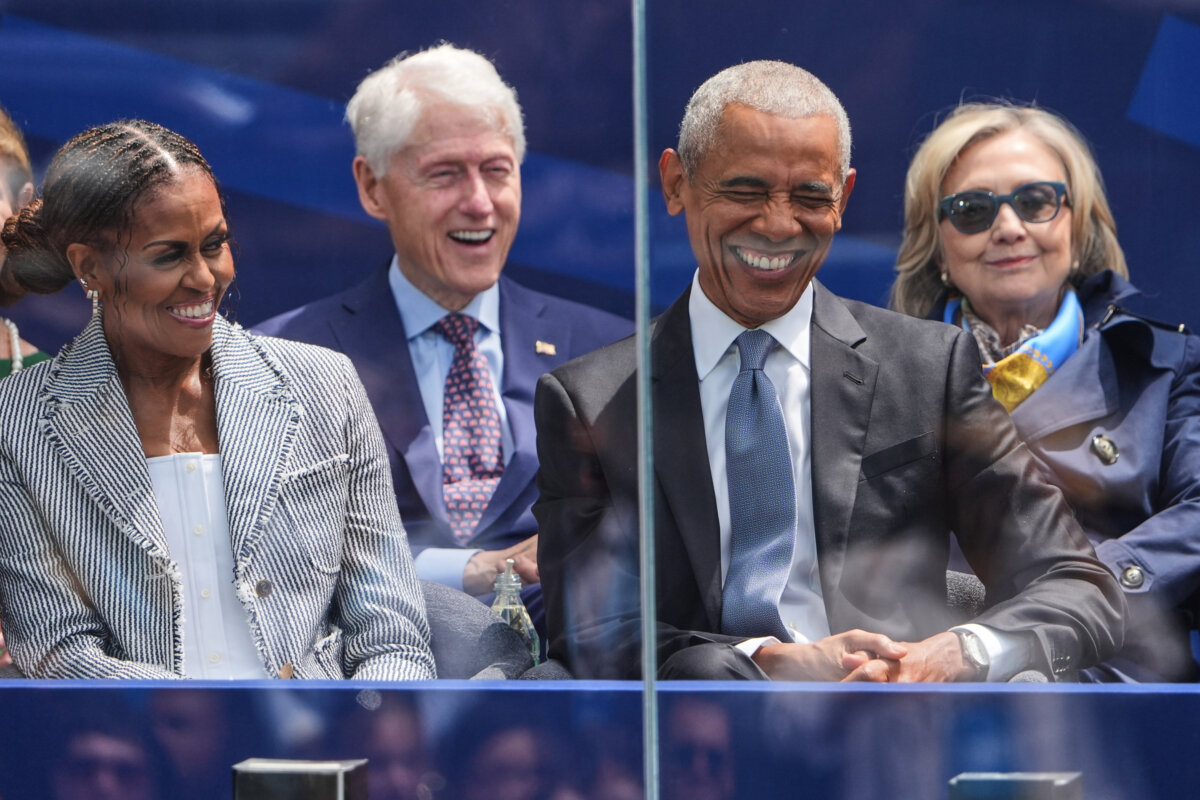 (L-R) Former first lady Michelle Obama, former President Bill Clinton, former President Barack Obama, and former first lady and Secretary of State Hillary Clinton on stage during the dedication ceremony of the Obama Presidential Center in Chicago, Ill., on July 18, 2026. (Jeff Roberson/AP Photo)