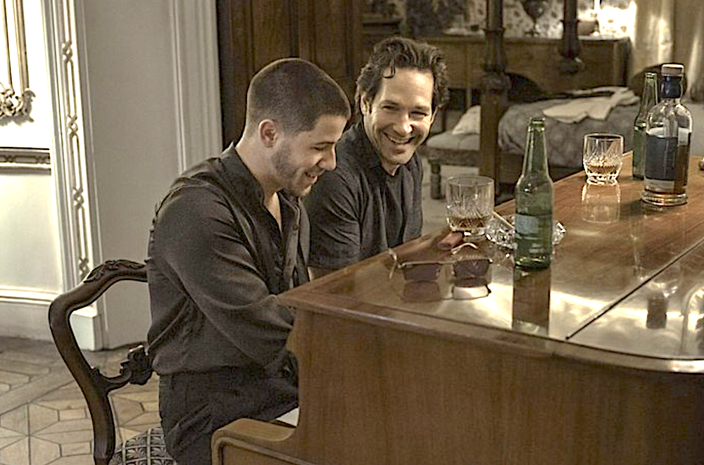 Two men seated at a piano in Power Ballad