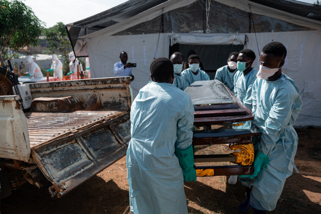 Volunteers with the Red Cross move a casket with a man who died from Ebola, in Bunia, Congo, on June 13, 2026. (Jospin Mwisha/AFP via Getty Images)
